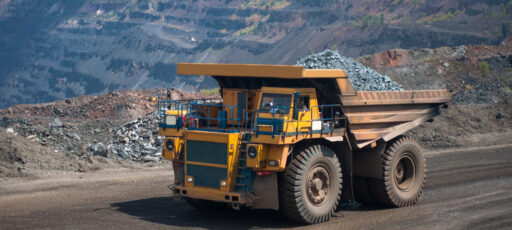 An electric drive mining truck for open-pit mining operations, on the road at the mine.