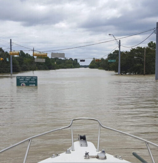 Flooded street, nine feet underwater, as seen from the bow of a boat.