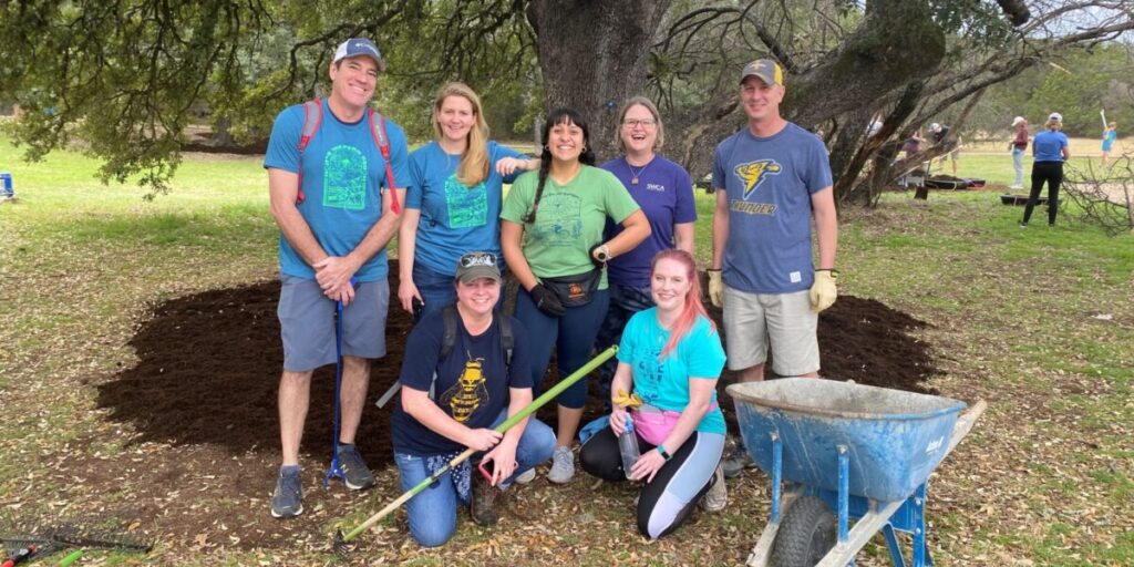 A group photo of seven people at their day of service location.