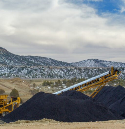 Large piles of coal and a conveyor belt system.