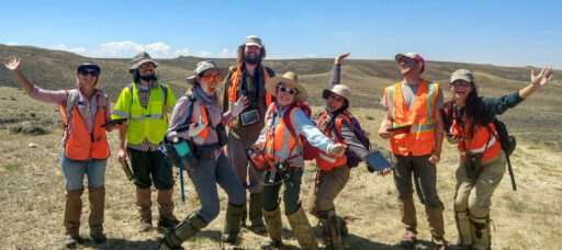 Eight SWCA employee fieldworkers pose for a group photo in the arid west.
